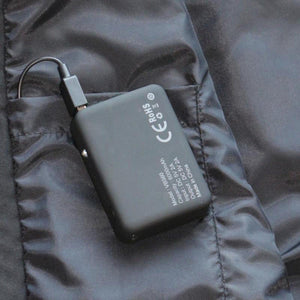 Volt Heat 6000mAh battery pack plugged into a black jacket pocket
