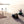Thule backpacks and duffel bags on a beach with people in the background
