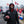Man wearing Kansas City Chiefs apparel holding a football at a tailgate party