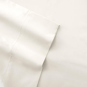 Close up of folded white cotton bed sheet with stitched hem detail