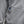 Close up of grey heathered hoodie pocket with V logo patch