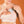 Person placing an Opal Cool cooling pad inside a sports bra