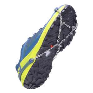 Blue and yellow trail running shoe with metal traction spikes attached to the sole