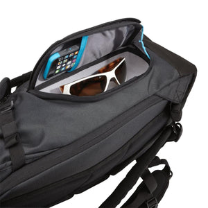 Thule backpack top pocket containing a smartphone and sunglasses