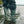 Person wearing green Baffin rubber boots splashing in shallow water