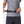 Person adjusting a black adjustable waist belt with a plastic buckle
