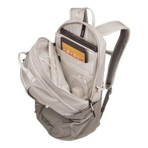 Open Thule backpack showing internal laptop and tablet compartments with mesh pockets