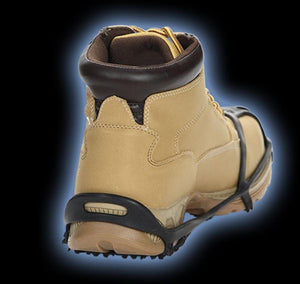 Due North traction aid attached to a tan work boot