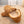 Acorn tan suede slippers with cream faux fur lining on carpet