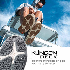 Person wearing Klingon Deck shoes on a boat showing the textured rubber soles for grip