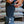 Hands adjusting a black gaiter over a black boot