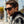 Man wearing black Smith sunglasses with a plaid shirt