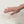 Hand pressing into white memory foam mattress topper