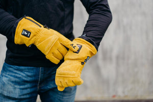 Person wearing yellow ActionHeat 7V battery heated gloves