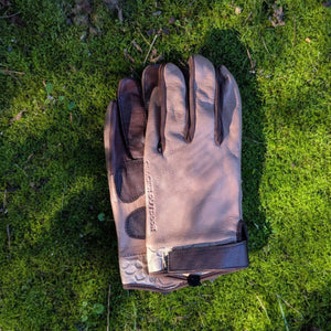 Glacier Glove leather work gloves on green moss