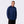 Man wearing a navy blue Mobile Warming quarter zip pullover with textured fabric