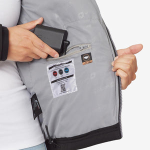 Person placing a Venture Heat battery pack into the interior pocket of a heated jacket