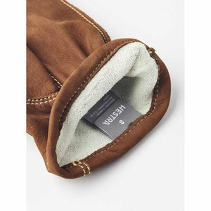 Interior of brown Hestra cowhide leather glove showing size label and white lining
