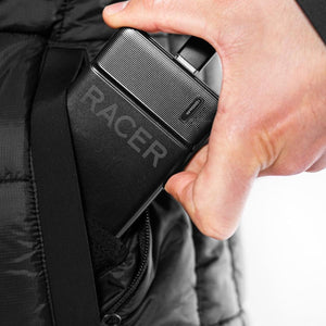Hand sliding a black Racer 10000mAh power bank into a jacket pocket