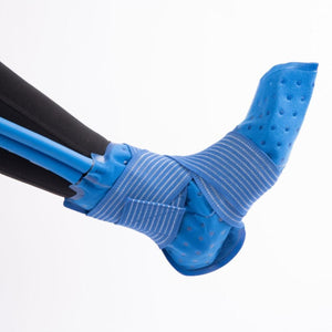 Polar Products blue ankle cold therapy wrap secured with elastic straps on a person