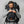 Man wearing a black Fjallraven backpack with a front accessory pouch