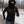 Person running in a Gobi Heat black fleece hoodie with a built in face mask in a snowy park