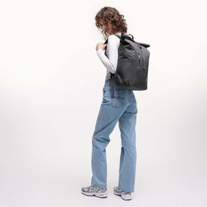 Person wearing a black Got Bag rolltop backpack