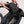 Hands placing a smartphone into a small black Got Bag pouch attached to a larger black tote bag