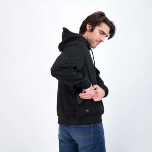 Man wearing a black Mobile Warming hooded sweatshirt with a battery pack in the pocket
