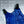 AlphaCool blue cooling vest with feature icons and text on a grey background with ice cubes