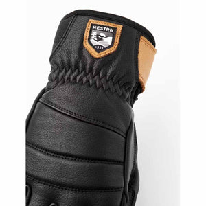 Black leather Hestra glove with tan leather wrist detail and Hestra brand patch