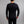 Back view of a man wearing a black Merino Skins long sleeve thermal top