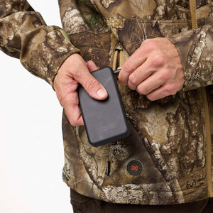 Person connecting a black power bank to a camo heated jacket