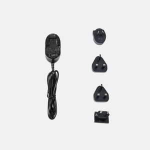 Gravity power adapter with four interchangeable international plug heads