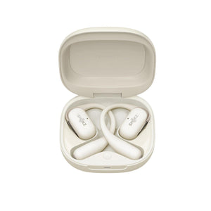 Shokz OpenFit 2 beige wireless earbuds inside an open charging case