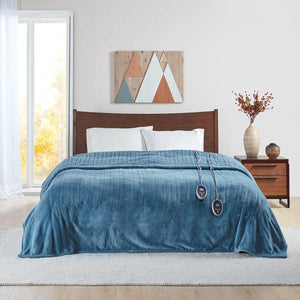 Beautyrest blue heated blanket with dual controllers on a bed
