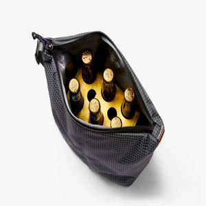 Black grid pattern cooler bag containing six glass bottles in a cardboard carrier