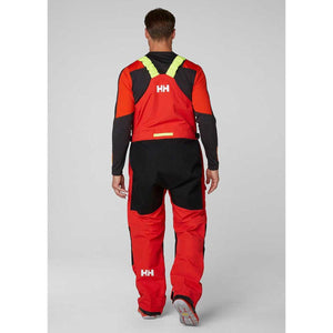 Back view of Helly Hansen red and black sailing bib trousers with yellow shoulder straps