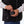 Person connecting a Mobile Warming battery pack to a heated vest pocket