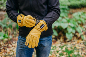 Person wearing tan ActionHeat battery heated gloves with battery pack inserted in cuff