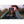 Man with beard using green binoculars outdoors