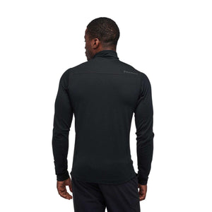 Back view of a man wearing a black Black Diamond long sleeve zip neck top