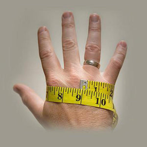 Hand being measured with a yellow tape measure
