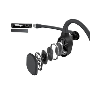Exploded view of black wireless earbud showing internal components and charging connector