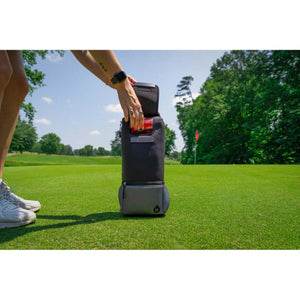 Person placing a beverage into a Kanga Coolers insulated sleeve on a golf course