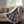 Woolrich plaid heated throw blanket with white sherpa lining draped over a beige sofa
