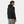 Man wearing a black Helly Hansen hooded jacket from the back