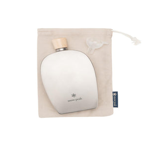 Snow Peak titanium flask with wooden cap and plastic funnel on a beige drawstring storage bag