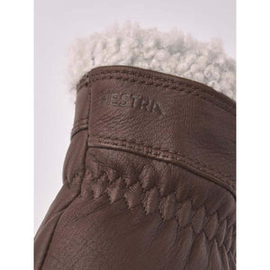 Brown leather Hestra glove cuff with grey wool lining