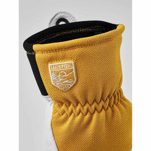 Yellow Hestra glove cuff with embroidered brand logo patch